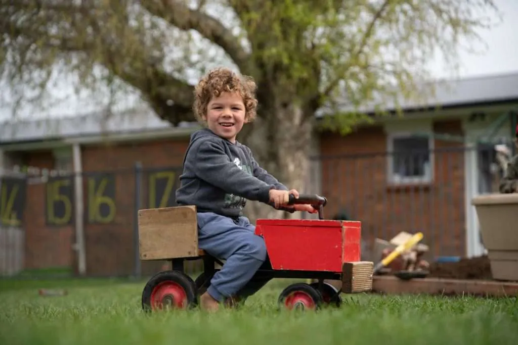 A boy on a toy tractor - Sami Tuomisalo photography